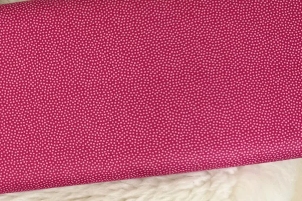 Baumwollstoff mit bunten, unregelmäßigen Punkten in pink